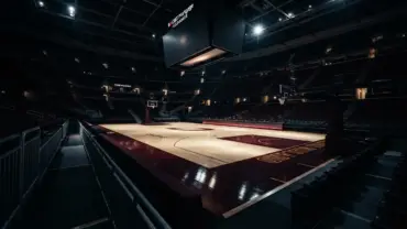 Empty Cleveland Cavaliers basketball court with dramatic arena lighting and wine-and-gold accents
