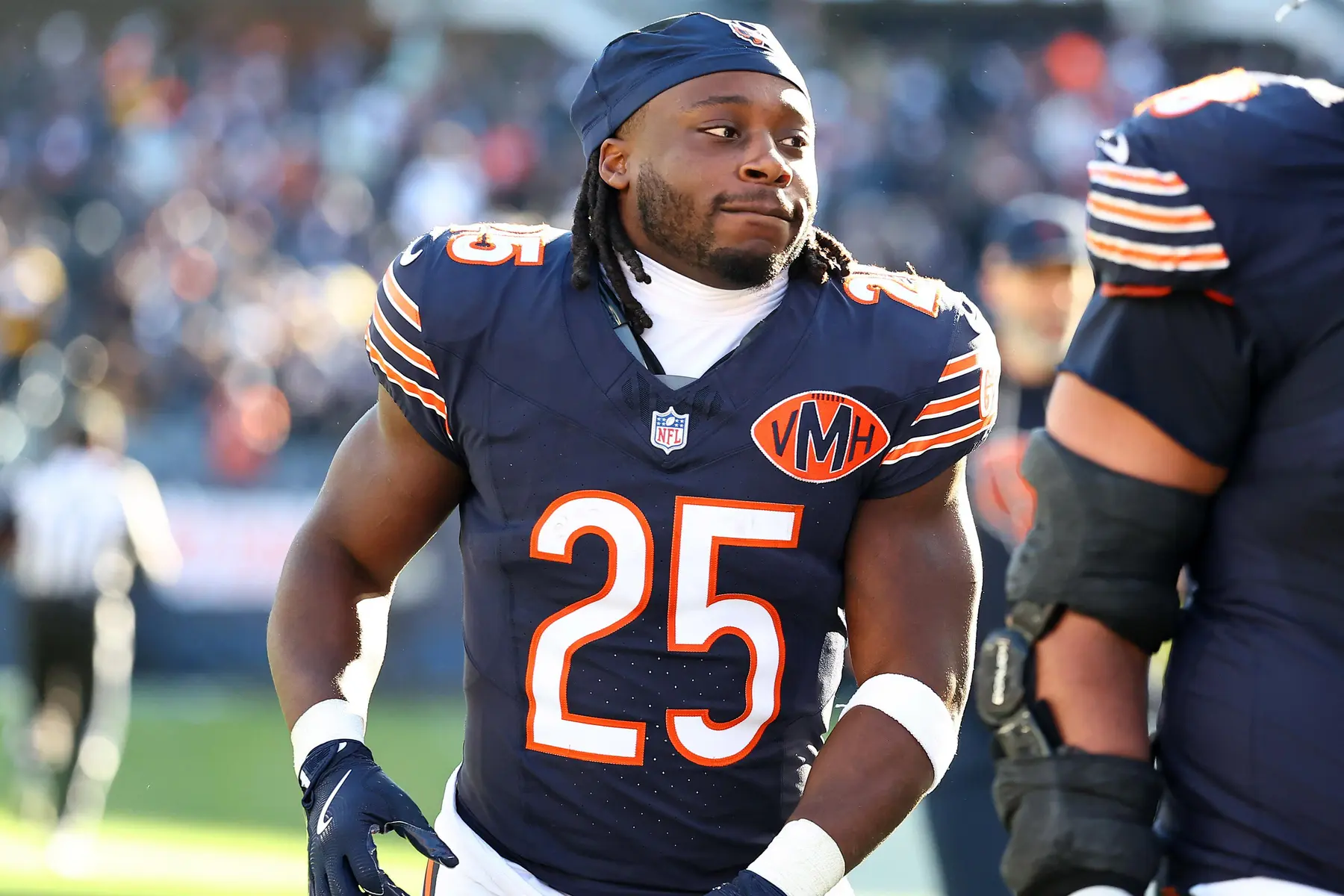 Chicago Bears player Kyle Monangai wearing a navy blue jersey with number 25 and a skull cap