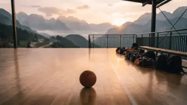 Basketball court in Slovenian mountains with Lakers team colors at golden hour