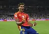 Marc Cucurella in Spain national team kit dribbling the ball during a match.