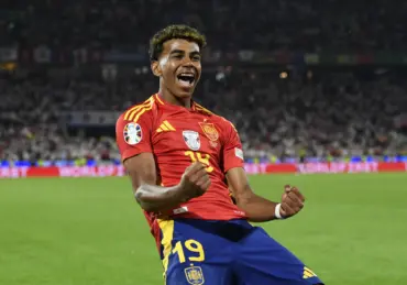 Marc Cucurella in Spain national team kit dribbling the ball during a match.