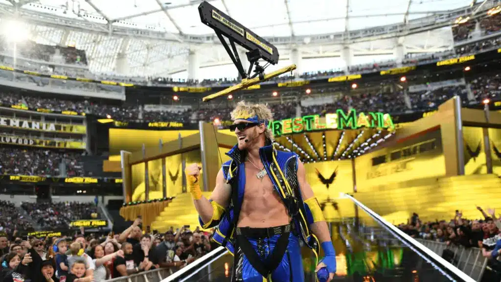 Logan Paul wearing a blue and gold vest and sunglasses during his WrestleMania entrance.