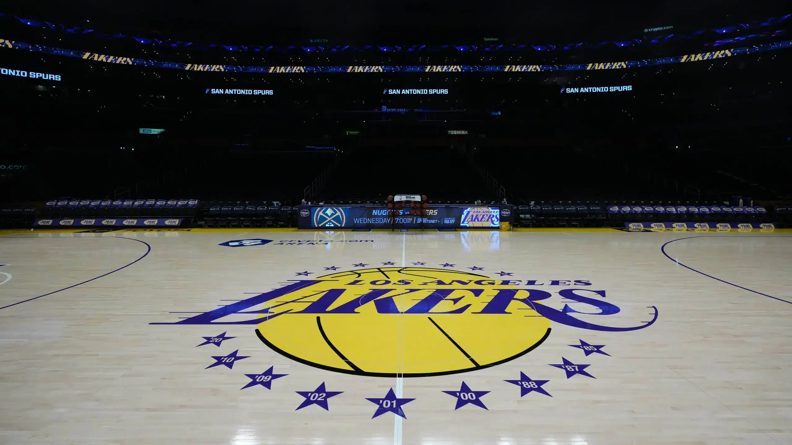 Los Angeles Lakers court logo featuring basketball and championship stars.