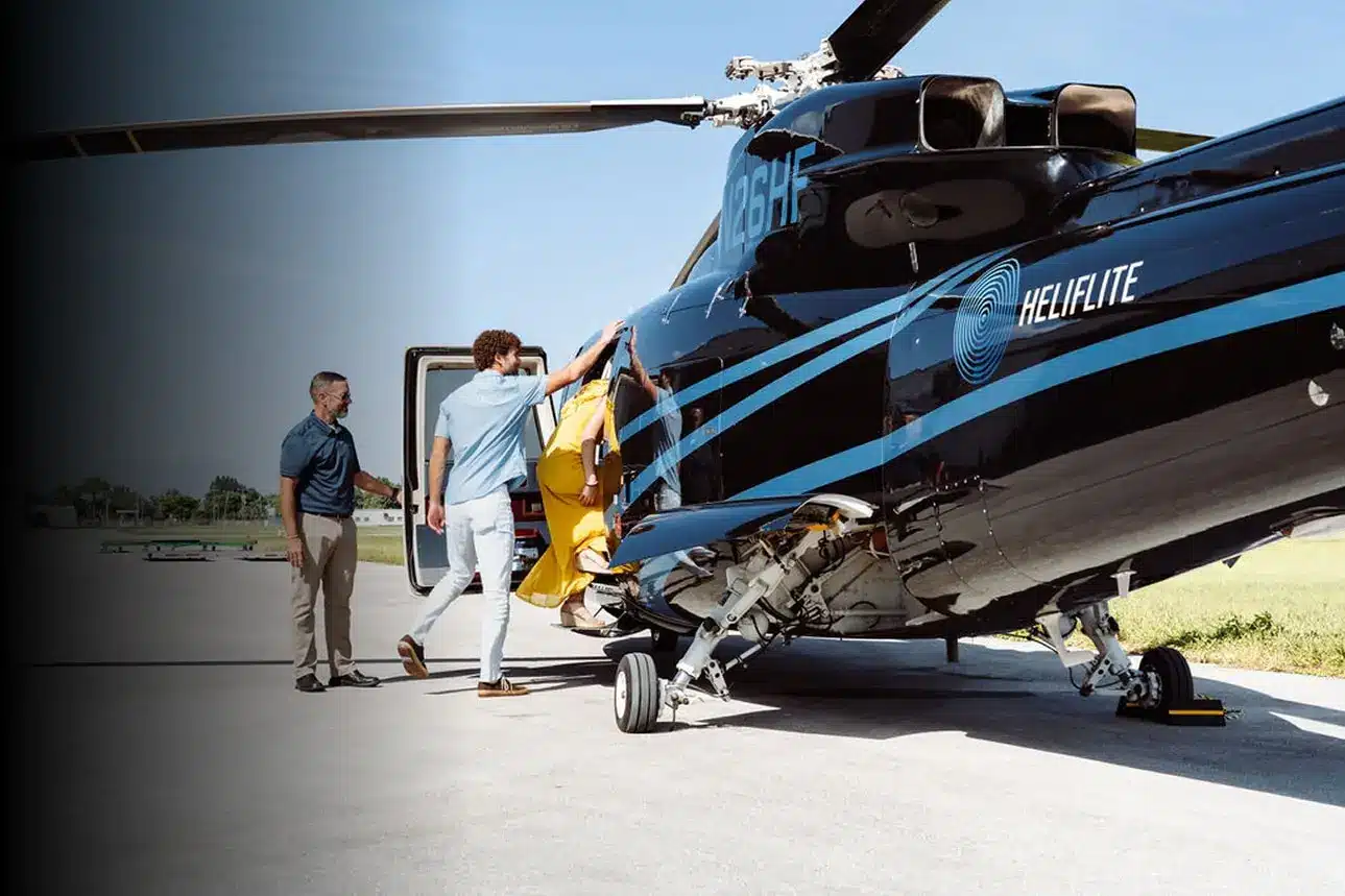 Passengers boarding a luxury helicopter at a private airstrip.