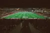 View of a packed stadium during a soccer match with players on the field.