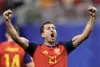 Marc Cucurella in Spain national team kit dribbling the ball during a match.