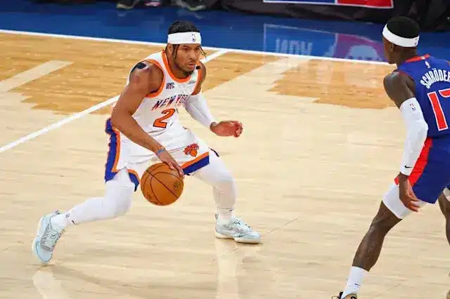Miles McBride dribbling a basketball on the court during a Knicks game.