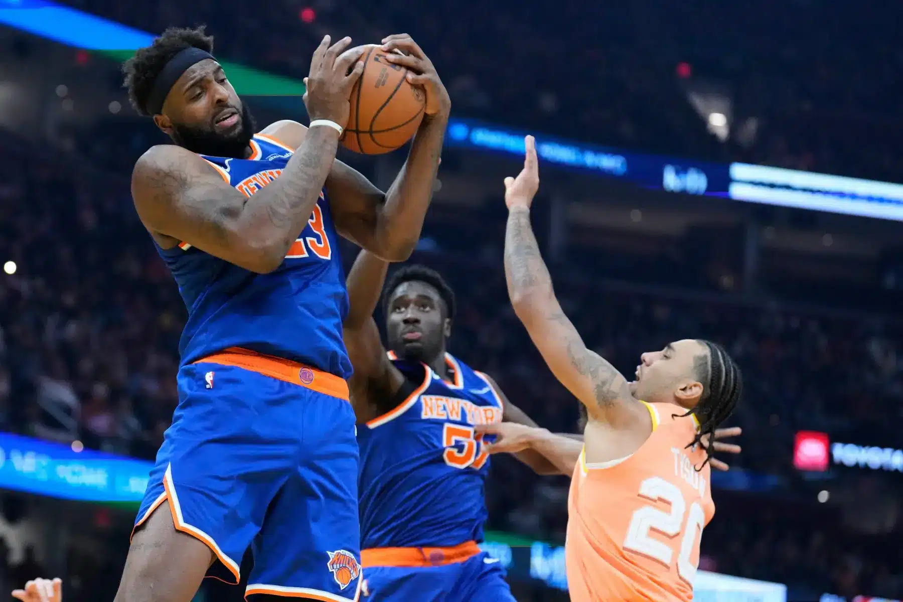 New York Knicks player Mitchell Robinson holding a basketball during a game
