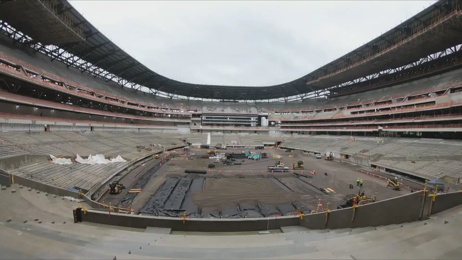 Construction progress inside Highmark Stadium with equipment and seating areas visible.