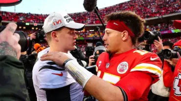Patrick Mahomes and Joe Burrow embrace post-game with fans and media around them.