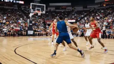 Basketball player driving to the basket during an intense Summer League game in Las Vegas arena