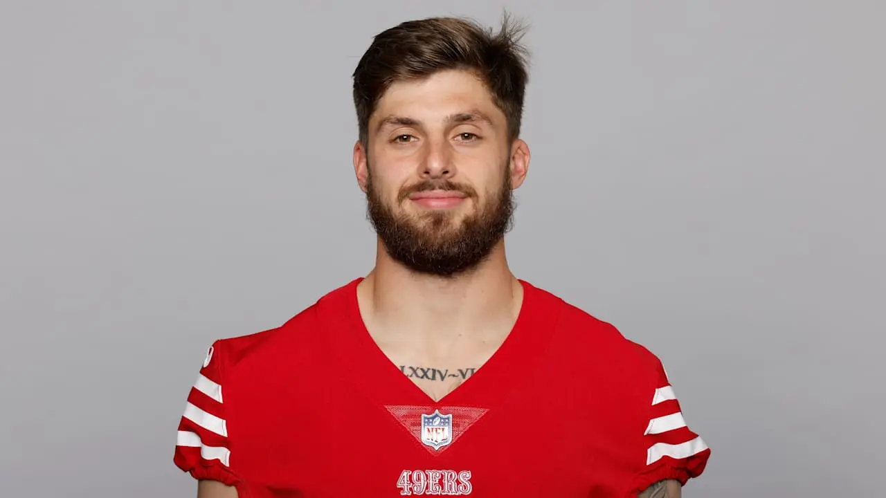 Ricky Pearsall in a red 49ers jersey posing for a headshot.
