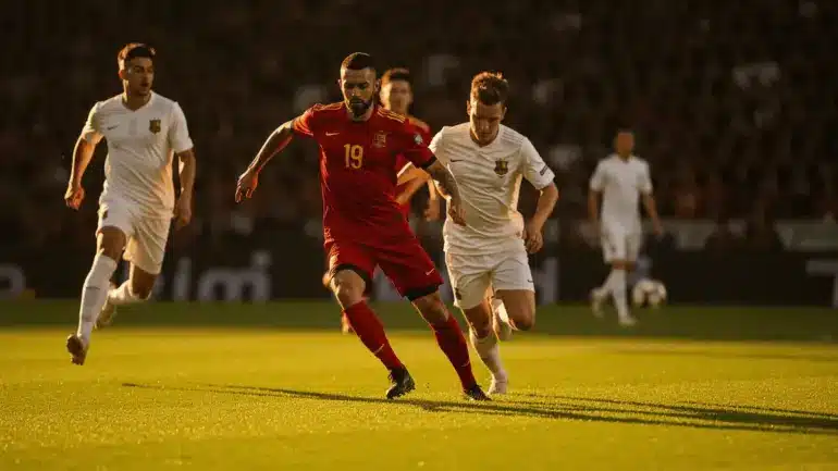 Spain soccer players in red jerseys attacking during an intense World Cup match on stadium pitch