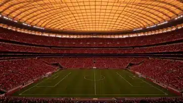 SoFi Stadium during World Cup 2026 knockout match with dramatic lighting and packed crowd