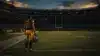 NFL wide receiver in burgundy uniform standing alone on empty football field at dusk