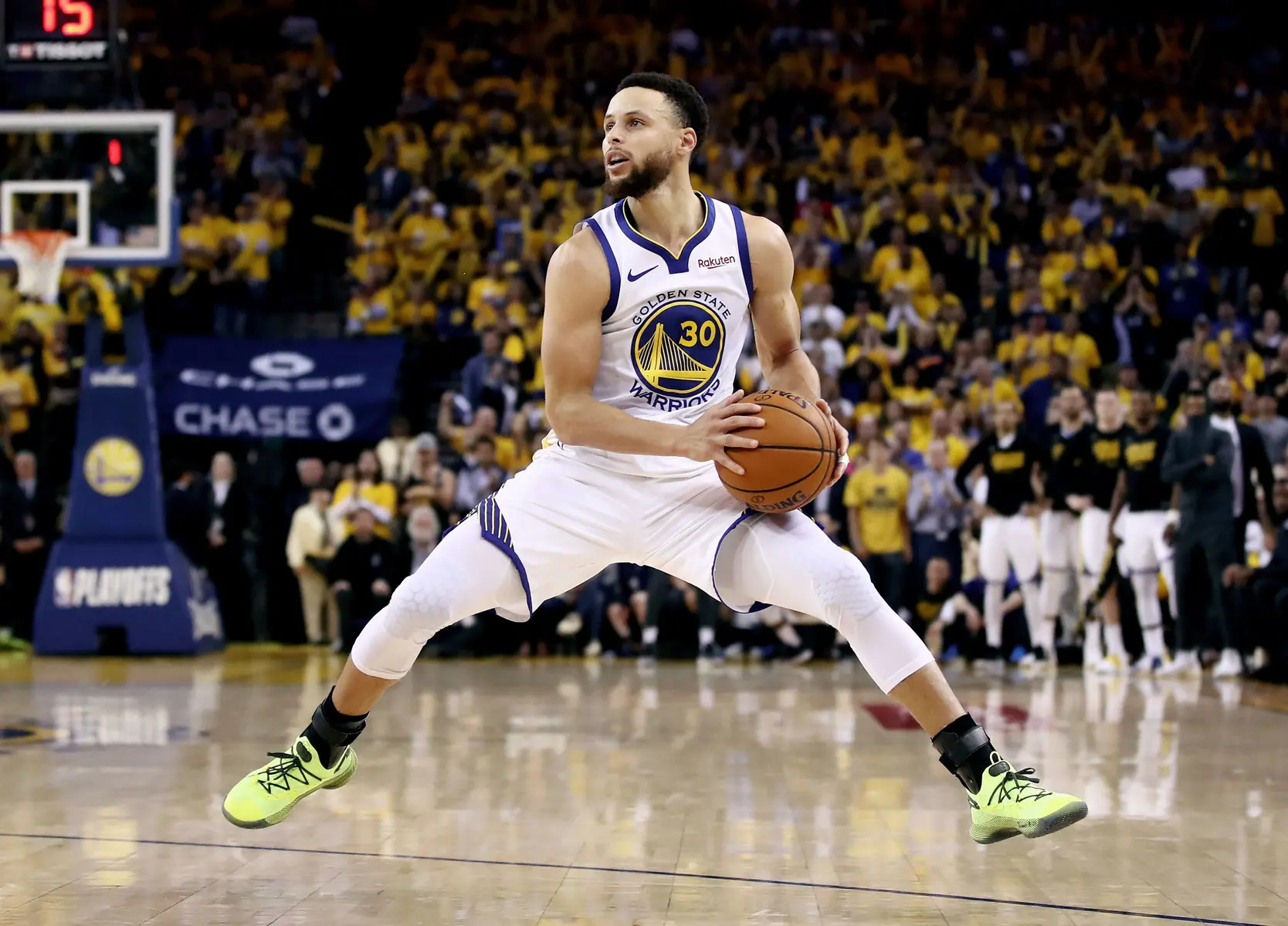 Stephen Curry dribbling the basketball on the court during a Warriors game.