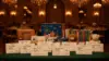 Elegant charity gala with donation displays and philanthropic symbols in luxurious ballroom setting
