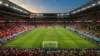 World Cup knockout stadium with Switzerland and Colombia team colors in crowd at dusk