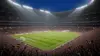 Packed soccer stadium at night with dramatic lighting during World Cup knockout match atmosphere