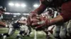 NFL defensive tackle breaking through offensive line at line of scrimmage during game