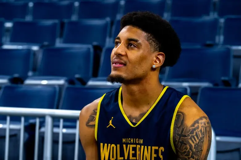 Yaxel Lendeborg wearing a Michigan Wolverines basketball jersey indoors.