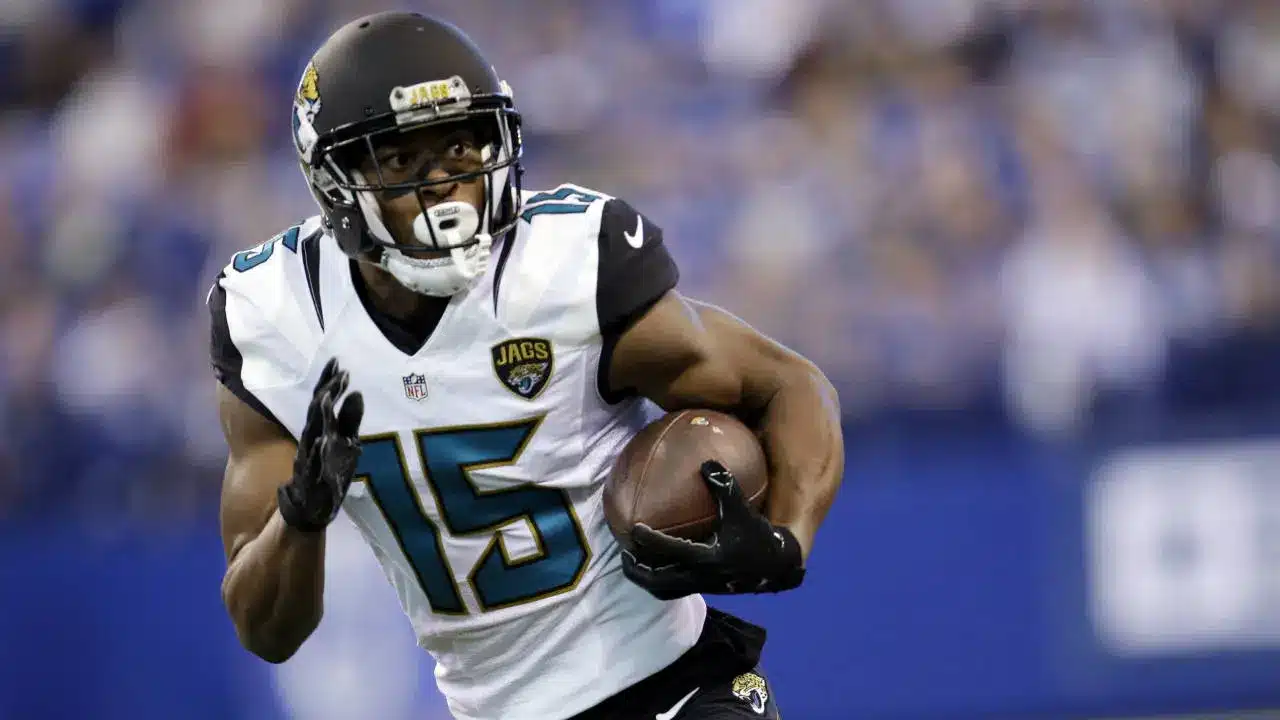 Allen Robinson wearing a Jacksonville Jaguars jersey number 15 and helmet, carrying a football during a game.