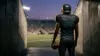 Retired football receiver walking toward an empty stadium after an 11-year NFL career