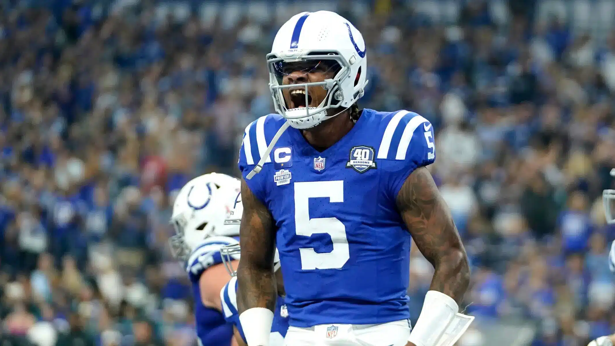 Indianapolis Colts quarterback Anthony Richardson wearing jersey number 5 and a helmet, shouting on the field.