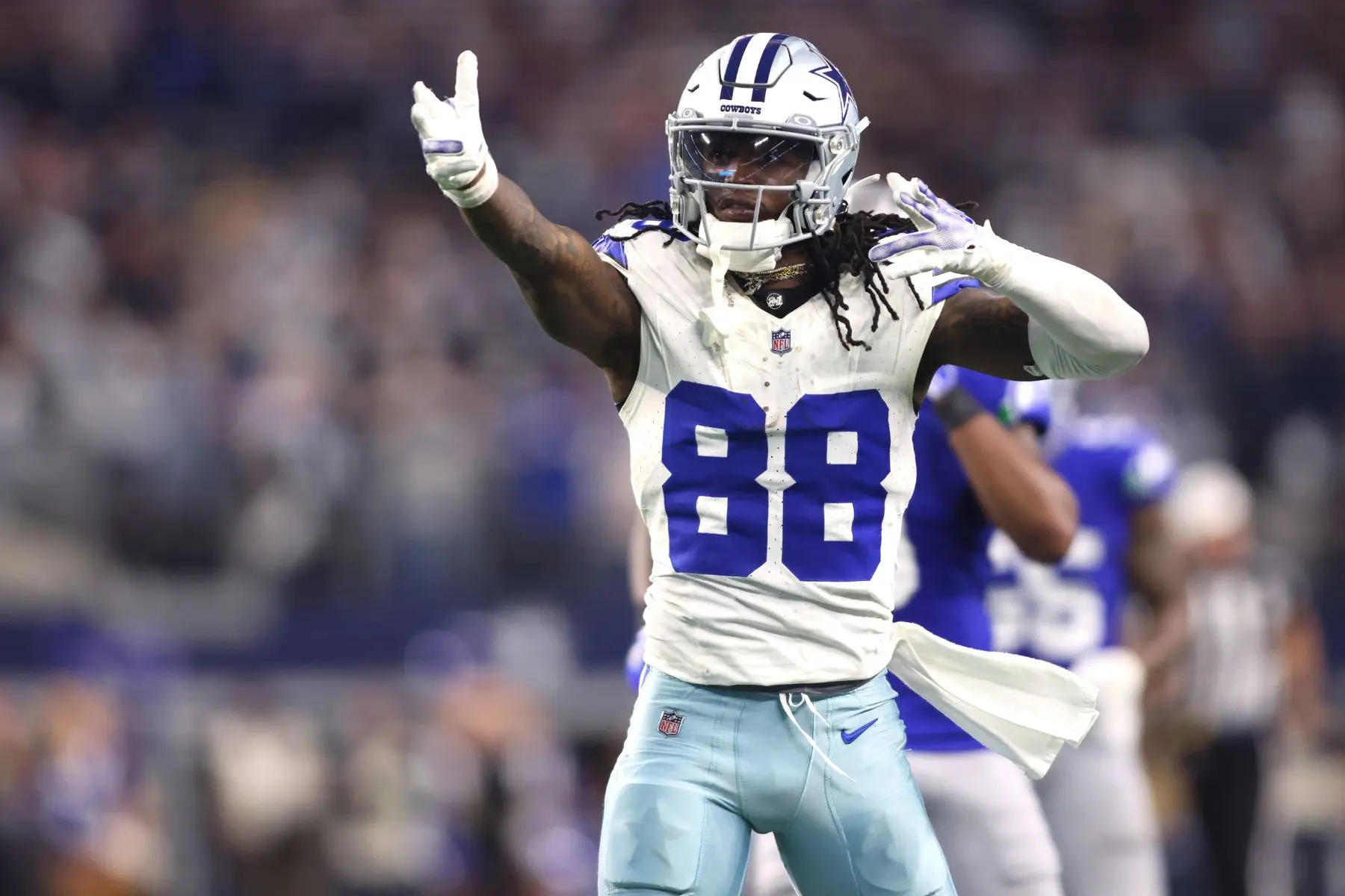 CeeDee Lamb of the Dallas Cowboys celebrating on the field wearing a white home jersey with number 88