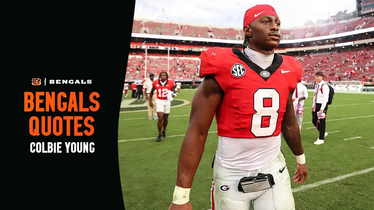 Colbie Young wearing a red Georgia Bulldogs football jersey and red headband on a stadium field.