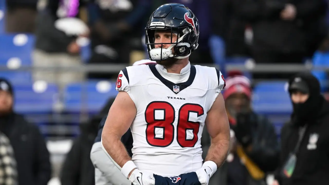 Houston Texans tight end Dalton Schultz wearing a white jersey with number 86 and a blue helmet