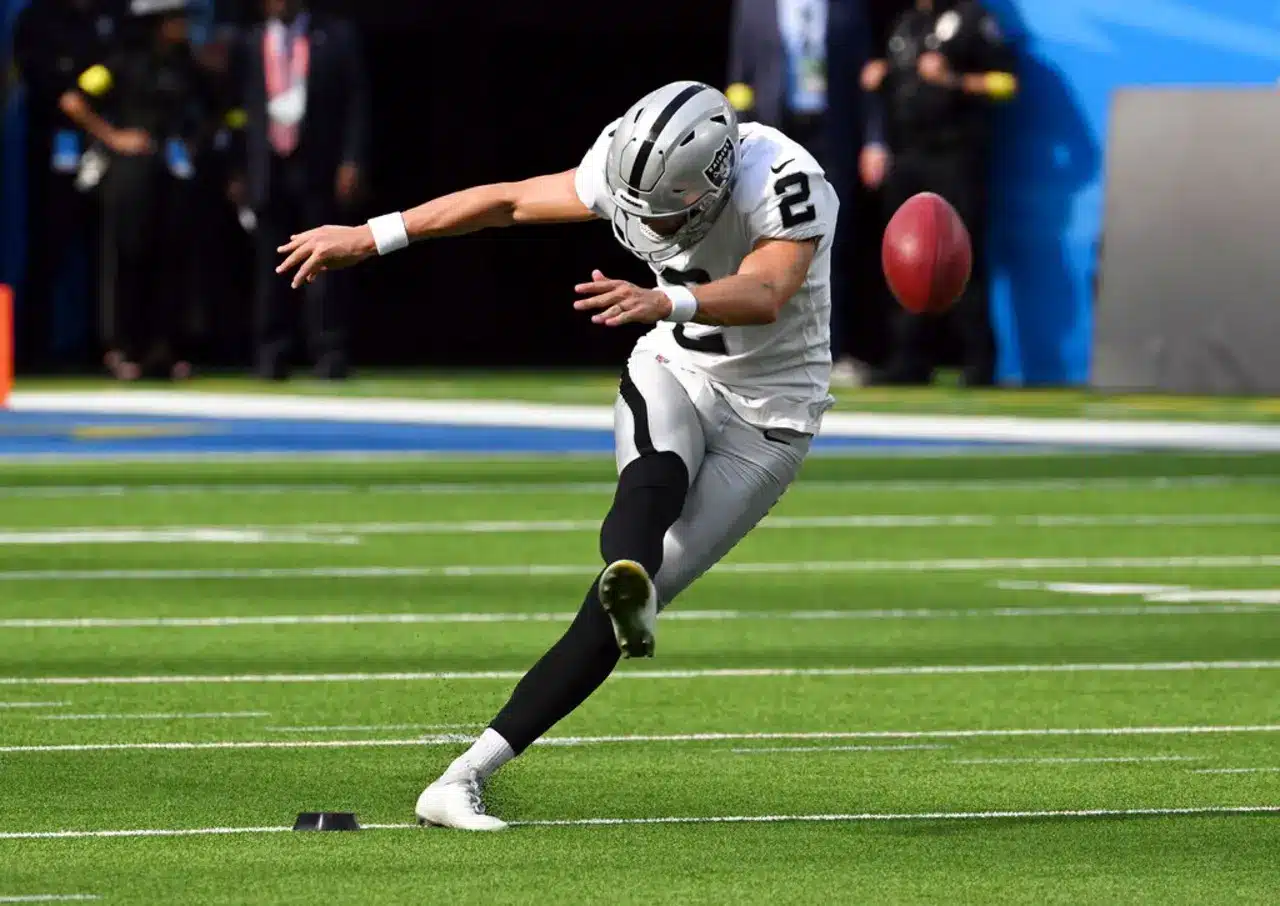 Las Vegas Raiders kicker Daniel Carlson kicking a football during a game