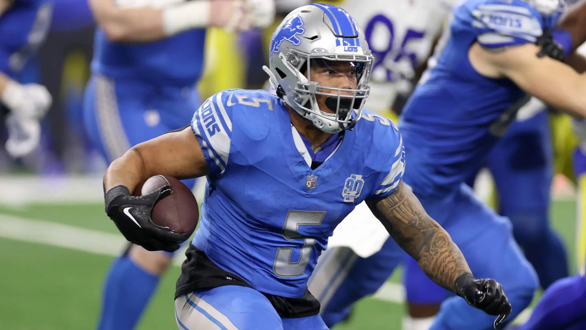 Detroit Lions running back David Montgomery carrying a football during a game.
