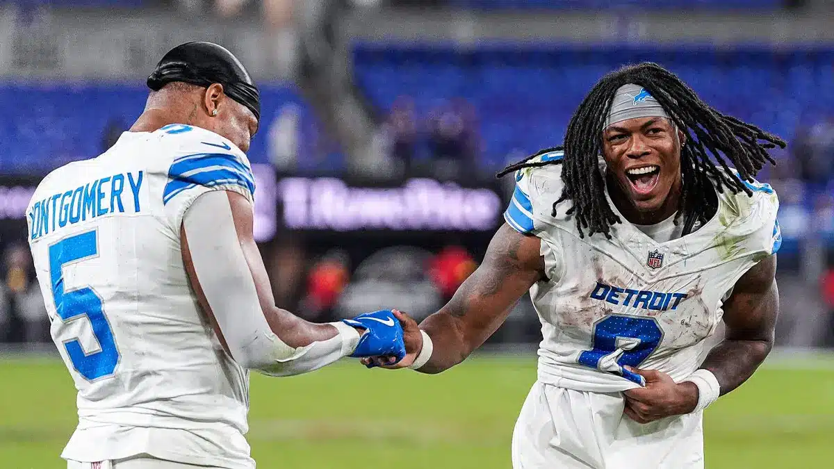 Detroit Lions running backs David Montgomery and Jahmyr Gibbs celebrating on the field