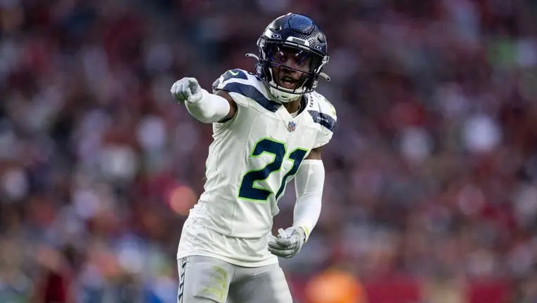 Seattle Seahawks cornerback Devon Witherspoon wearing number 21 celebrating on the field.