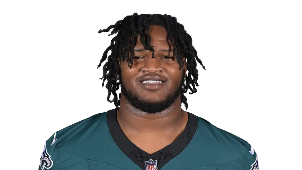 Headshot of Jalen Carter wearing a Philadelphia Eagles midnight green jersey against a white background