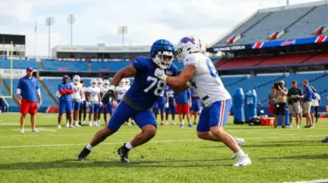 Anonymous Bills linebackers compete in a tense training camp roster battle on the practice field.