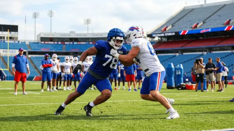 Anonymous Bills linebackers compete in a tense training camp roster battle on the practice field.