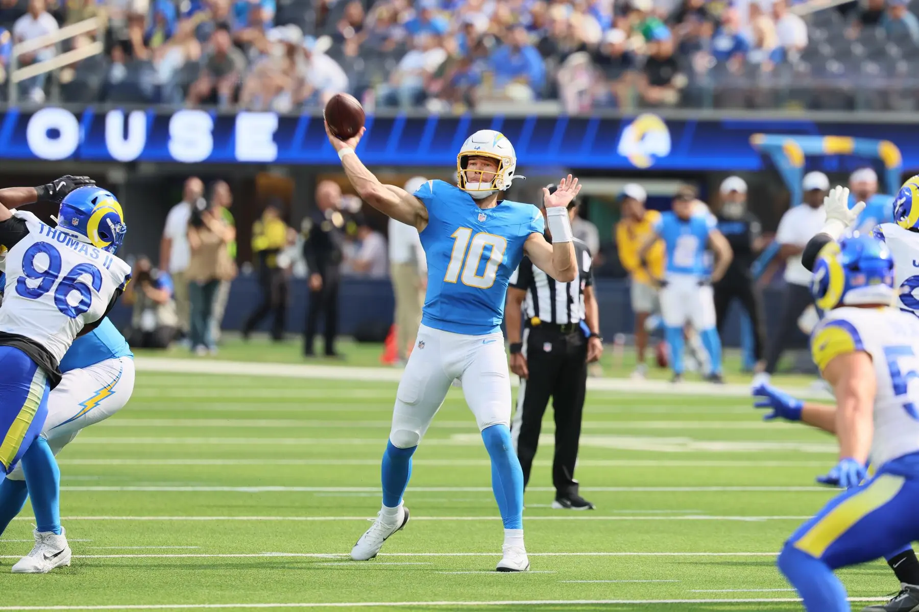 Justin Herbert of the Los Angeles Chargers throwing a football during a game against the Rams.