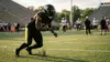 Steelers defensive lineman driving through a practice rep on a football field