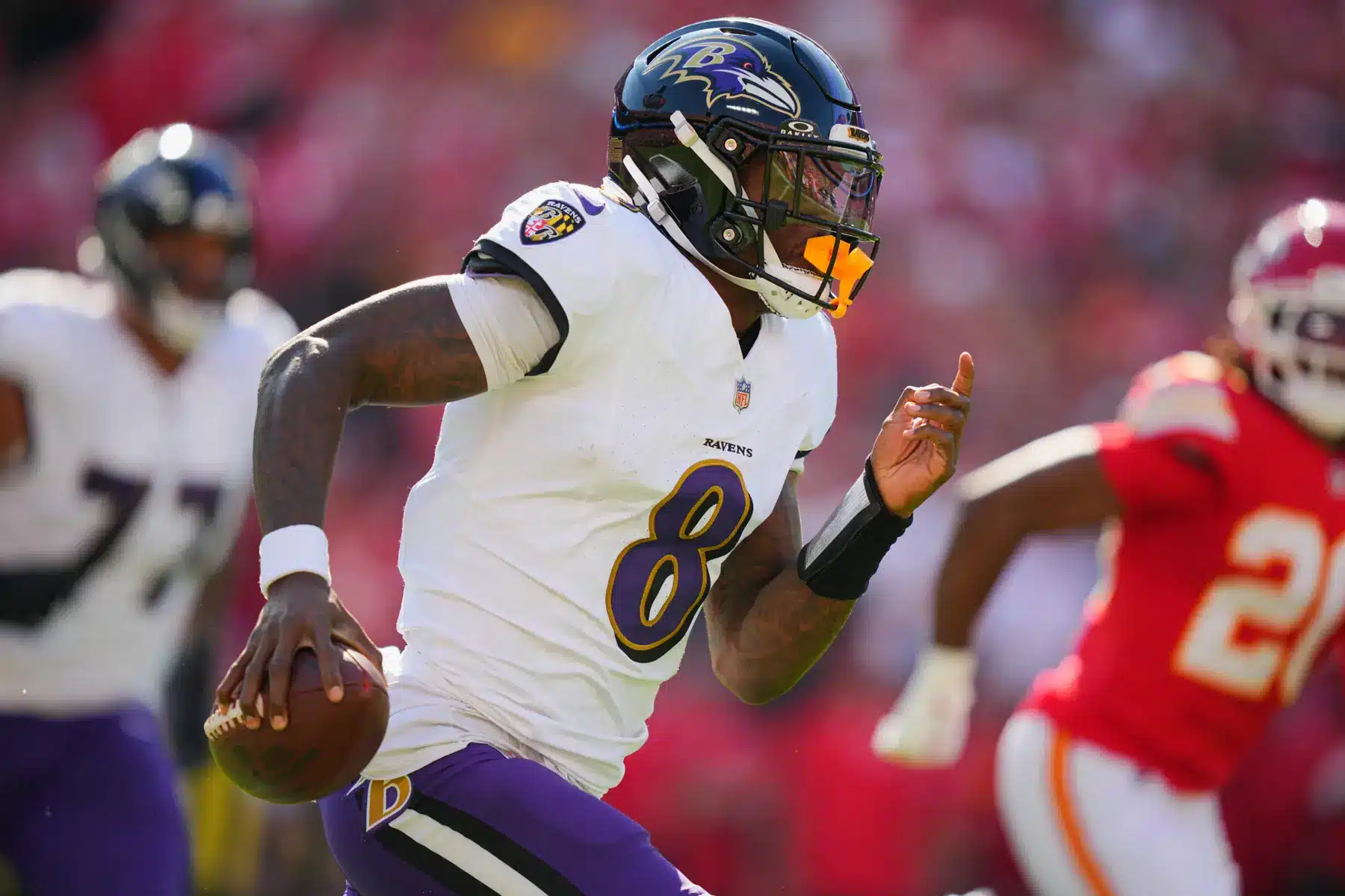 Lamar Jackson of the Baltimore Ravens running with a football during a game