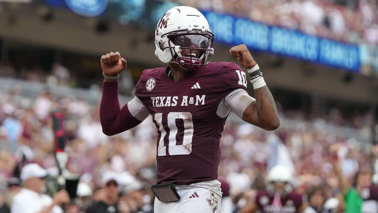 Texas A&M quarterback Marcel Reed celebrating with clenched fists on the football field
