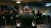 Frustrated football coach reacts during a tense postgame press conference after a shutout loss