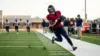 Houston Texans-inspired running back making a long touchdown catch during a football practice simulation
