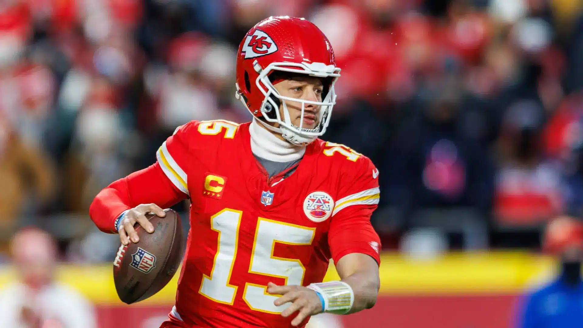 Patrick Mahomes of the Kansas City Chiefs wearing a red jersey and helmet while holding a football