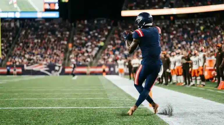 Anonymous Patriots-inspired receiver making a sideline catch during a decisive preseason roster audition