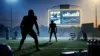Defensive players silhouetted on a Rams-inspired field beside an abstract salary-cap scoreboard