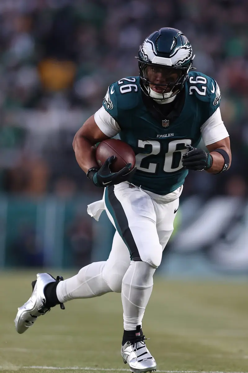 Saquon Barkley running with the football while wearing a Philadelphia Eagles uniform