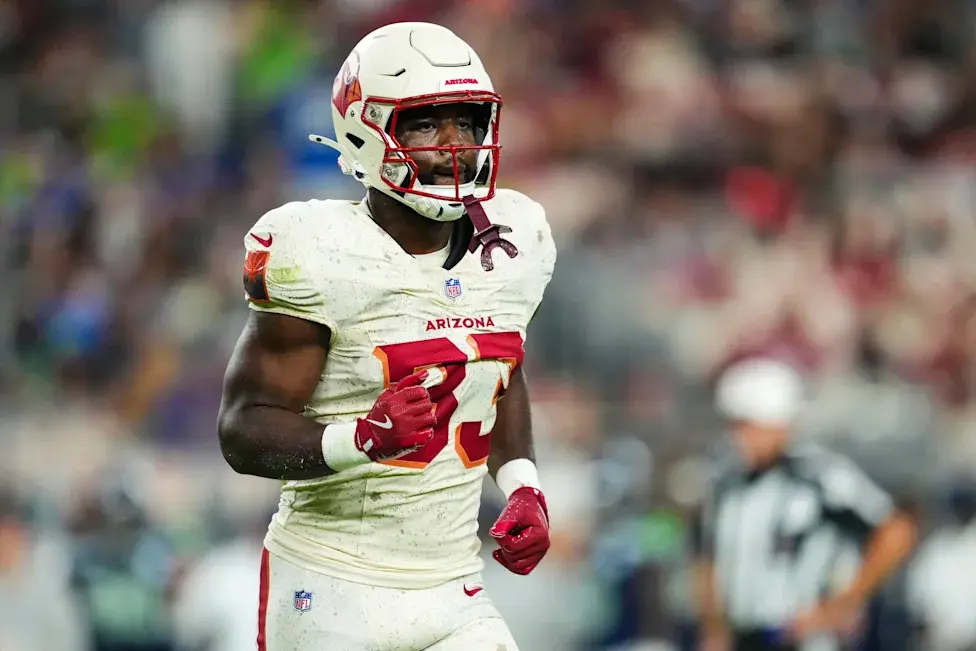 Trey Benson of the Arizona Cardinals wearing a white jersey and helmet during a game