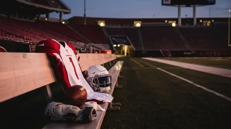 Arizona Cardinals football gear left on a sideline bench after Trey Benson’s injury-related waiver